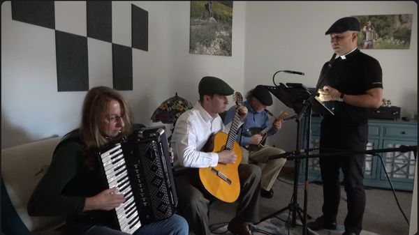 Musicians playing accordion and guitars together indoors